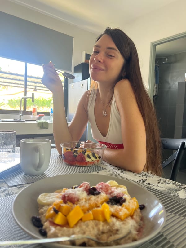 Woman prepares fruit-topped oatmeal breakfast in Thai kitchen