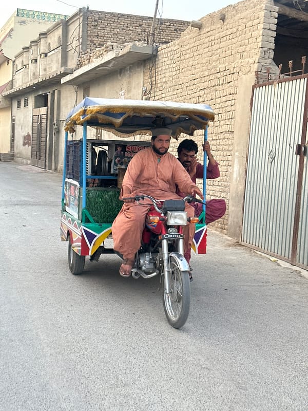Decorated red rickshaw parked on a Quetta street