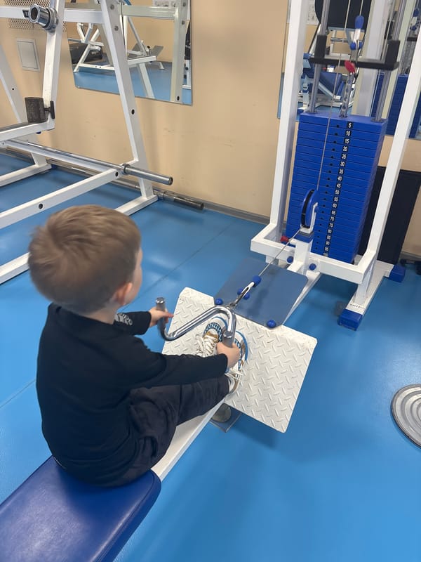 Young boy uses gym equipment in Chaikovsky, Russia