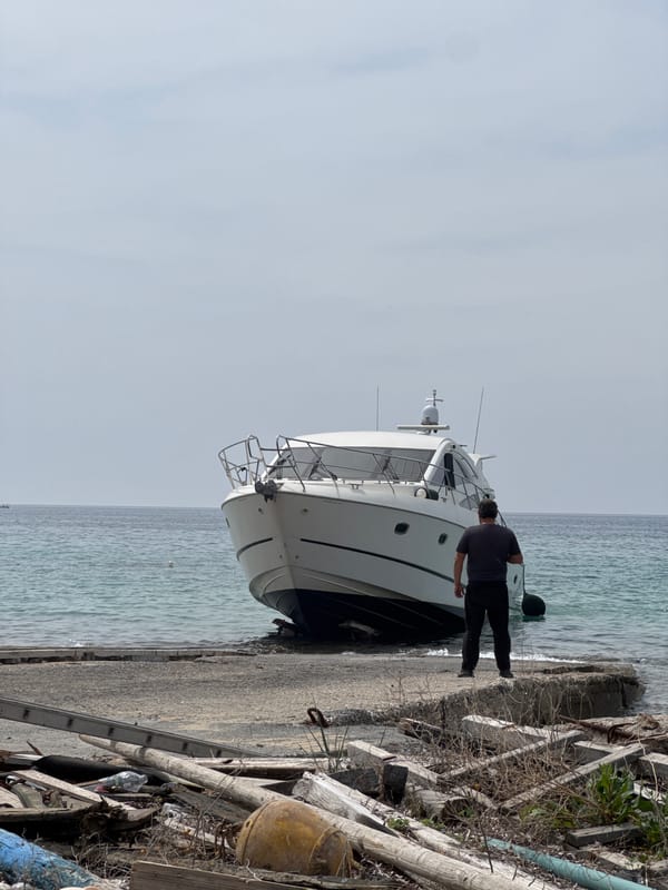 Man spotted beside white yacht on Greek rocky shore