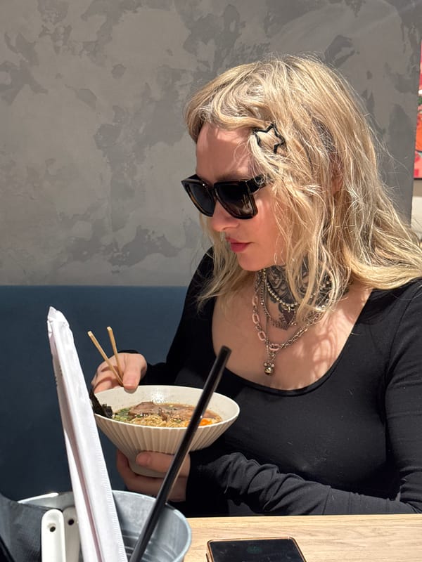 Woman enjoys noodle meal at undisclosed location