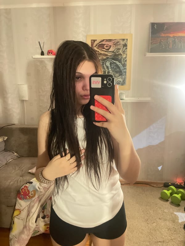 Woman takes mirror selfie indoors in Saint Petersburg