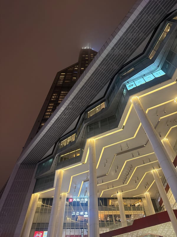 Modern glass building with zigzag design photographed in Shanghai
