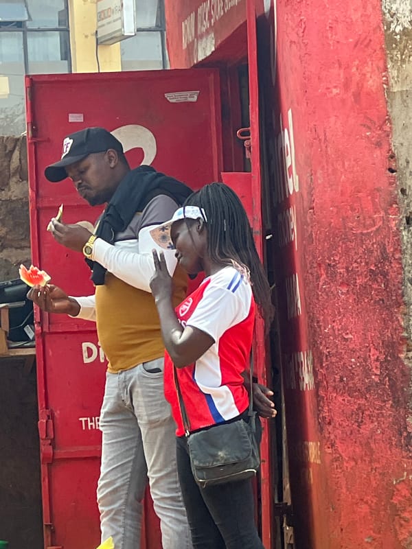 Two people share watermelon outdoors in Nyeri, Kenya