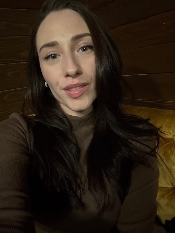 Woman in brown top observed indoors in Saint Petersburg