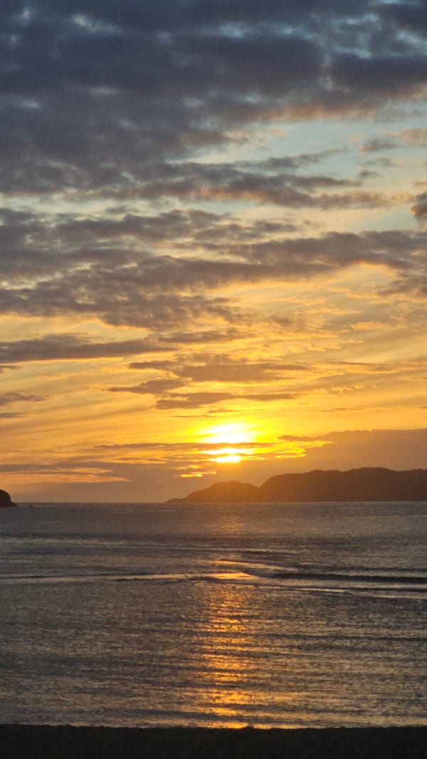 Sunset over the Barents Sea, framed by Teriberka's wooden huts