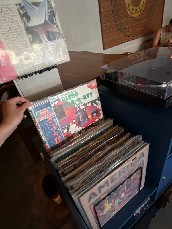 Vinyl record browsing session captured in Mengwi, Indonesia