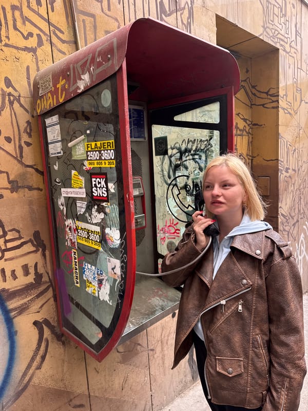 Woman Uses Red Phone Booth in Belgrade