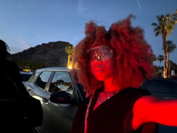 Person photographed in dramatic red lighting at La Quinta dusk