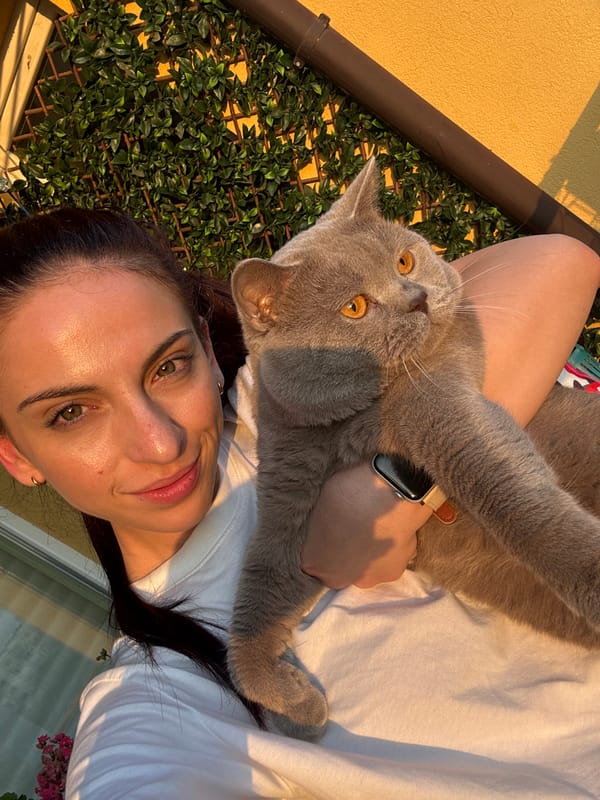 Woman and cat enjoy golden hour on Varna balcony