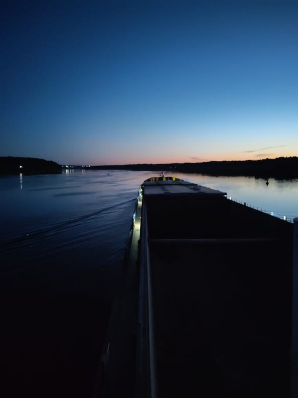 Cargo ship and radar boat on a Russian river at dusk