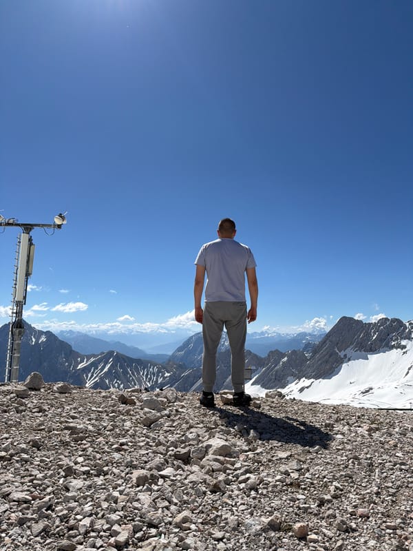 Man views Alpine panorama from rocky overlook in Garmisch-Partenkirchen