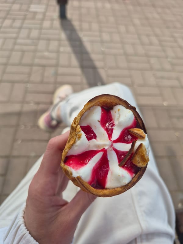 Person with ice cream cone photographed on sunny morning
