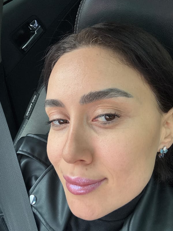 Woman takes selfies in car passenger seat in Tbilisi