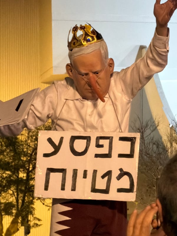 Nighttime protest with banners, masks draws crowds in Tel Aviv