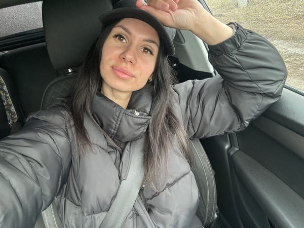 Woman in black jacket observed in car, Russia
