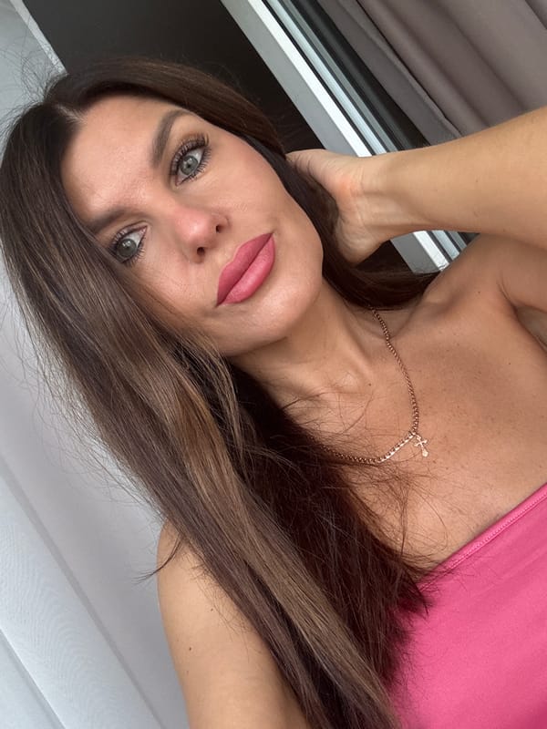 Selfie session in Chaikovsky, pink top and gold cross necklace