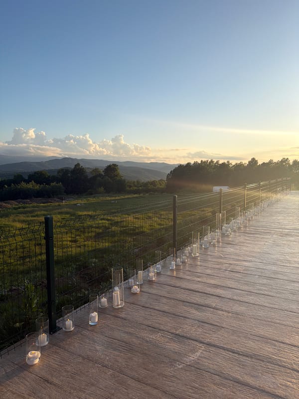 Candlelit gathering overlooks Bulgarian countryside at sunset