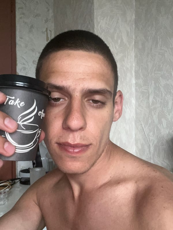 Man with coffee cup photographed indoors in Sofia