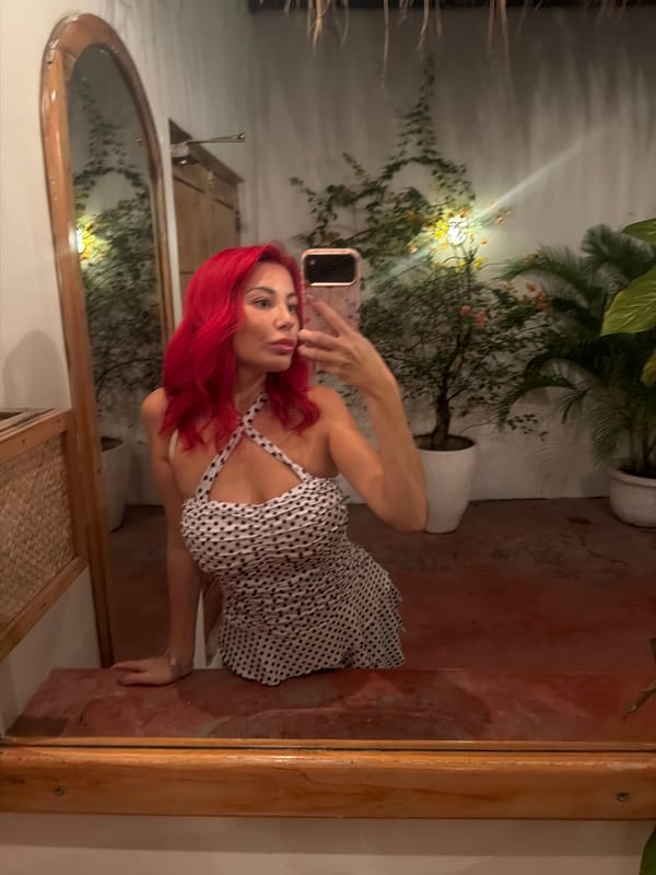 Mirror selfie in a stylish Kuta bathroom, polka dot dress