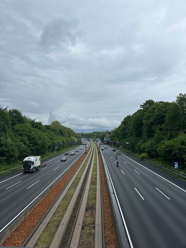 Regular traffic flows on Essen highway under cloudy skies