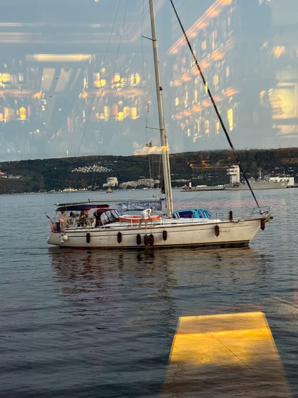 Sailboat moored off the Varna coastline with city backdrop