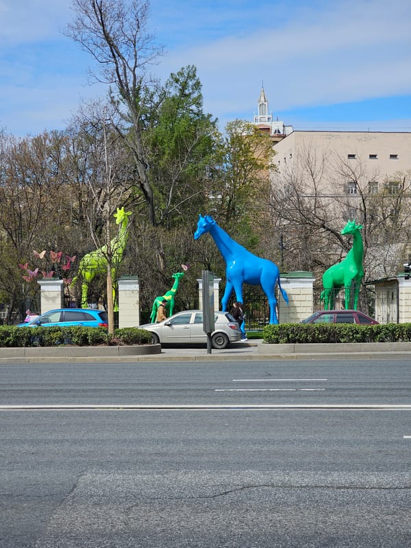 Moscow street scenes feature Stalinist buildings and decorative giraffes