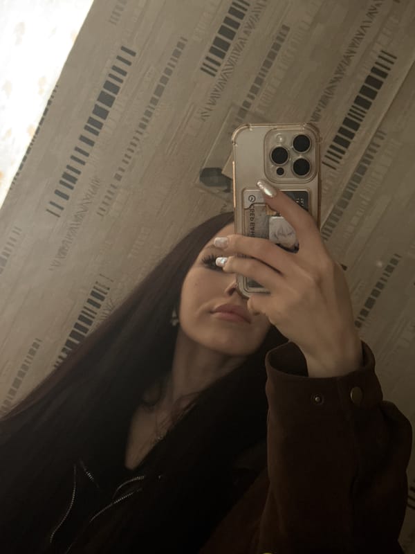 Person takes mirror selfies in Izhevsk indoor setting