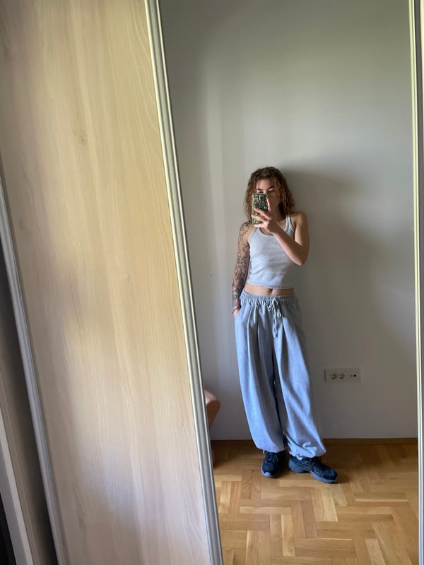 Tattooed woman photographed with drink indoors in Montenegro