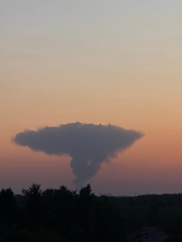 Triangular cloud formation and crescent moon observed during evening twilight