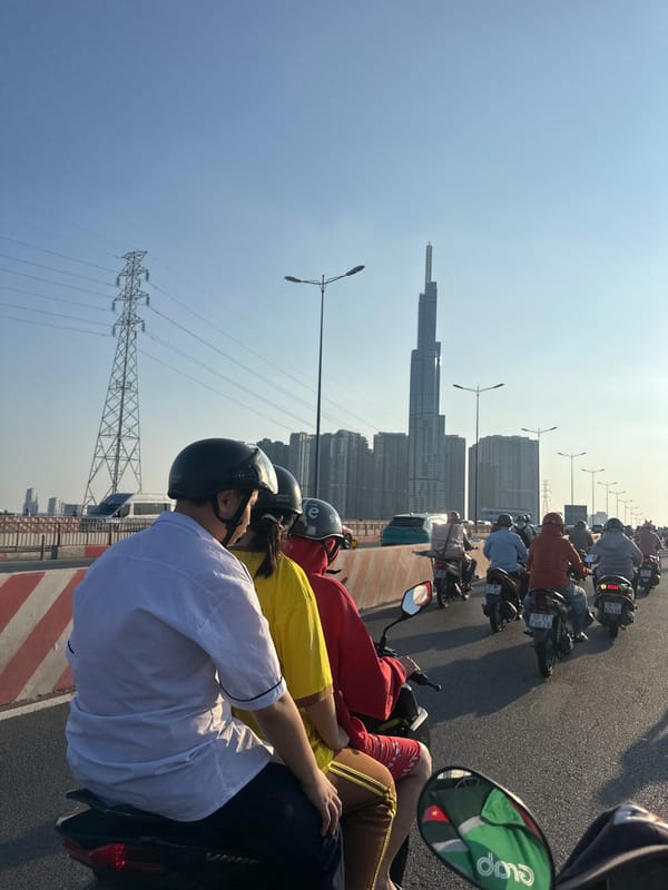 Motorbike riders cross bridge together in Thủ Đức, Vietnam