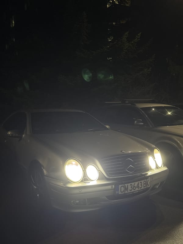 Mercedes-Benz parked with headlights on at night in Smolyan