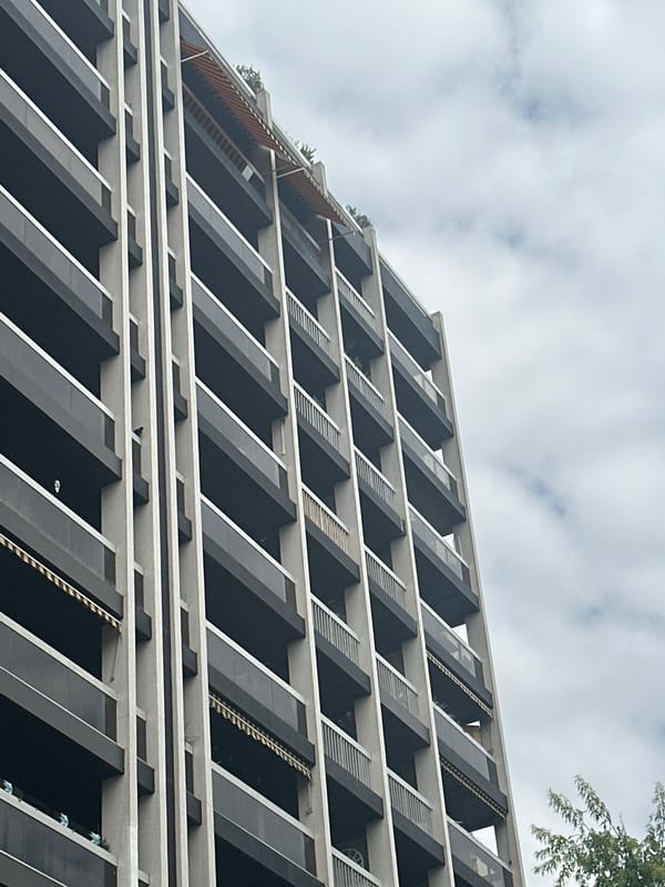 Modern Paris residential building with dark balconies and silver railings
