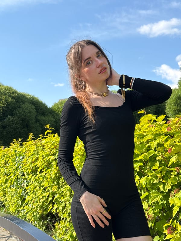 Woman in black outfit photographed during outdoor session