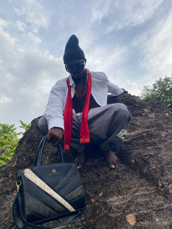 Person photographed sitting on rock formation in Achara, Nigeria