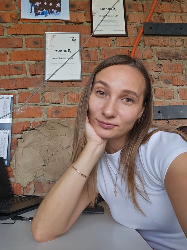 Woman takes selfie against brick wall in Chaikovsky