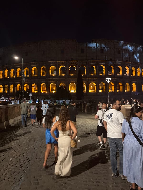 Red flares and live guitar outside the Colosseum at night