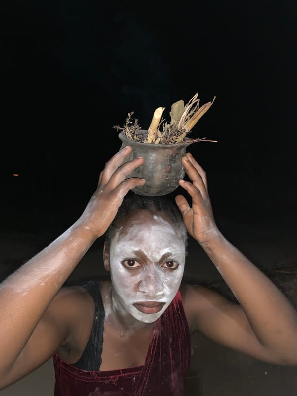 Traditional ceremony observed in Kukum involving face paint, flames