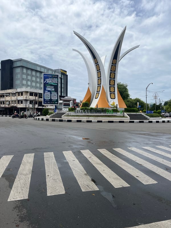 Banda Aceh roundabout monument and wet streets by scooter