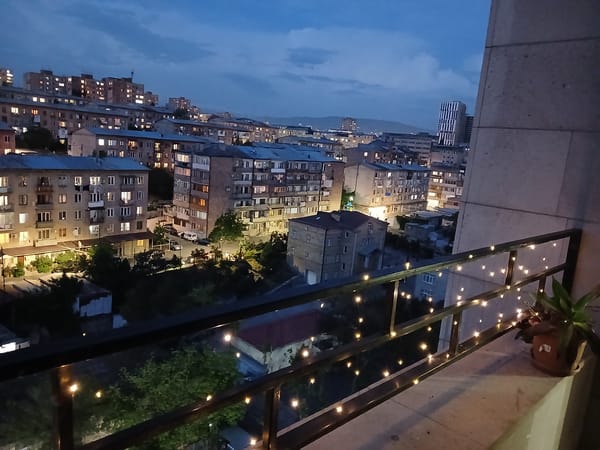 Twilight city skyline viewed from decorated balcony