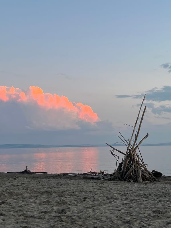 Sunset over calm water at a Siberian lakeshore
