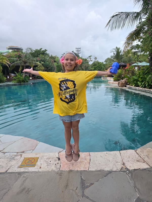 Family enjoys poolside recreation at Kuta resort