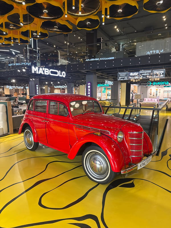 Vintage car and wheel installation documented indoors