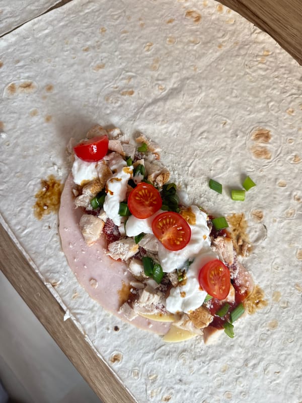 Early morning tortilla wrap preparation captured on wooden surface