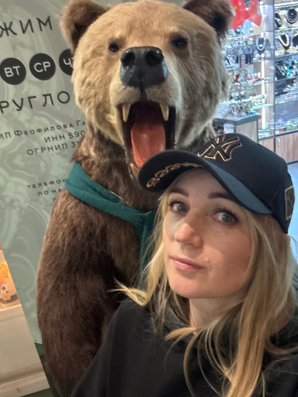 Woman takes selfie with stuffed bear in Russian shop