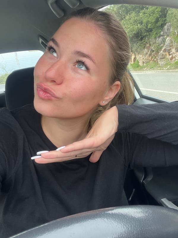 Woman applies cosmetics in car in Montenegro