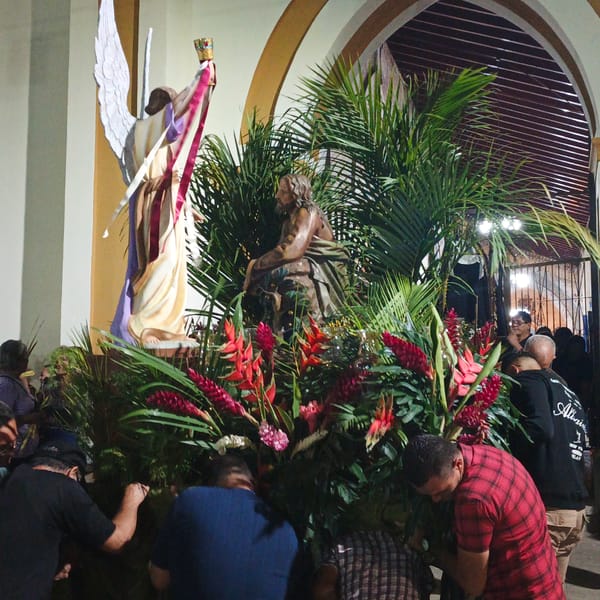 Religious procession with statues and marching band in Tinaquillo