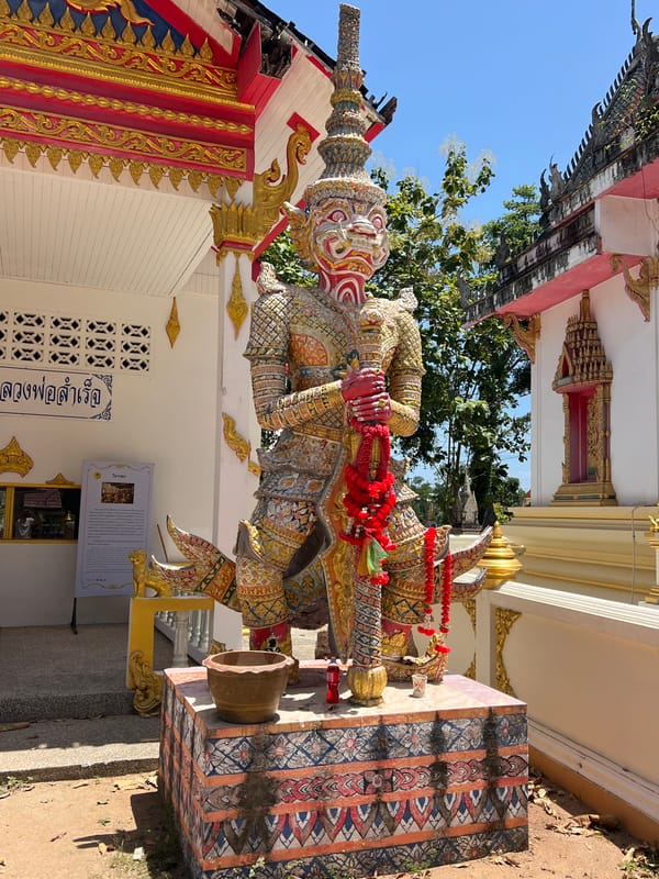 Ornate guardian statues and Ganesh outside a Ko Samui temple