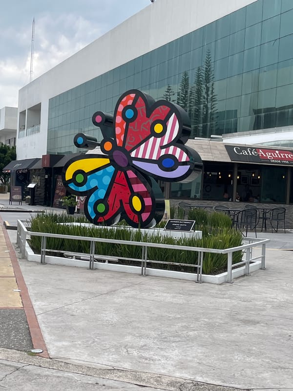 Bold public art: butterfly sculpture and disco ball basketball hoop