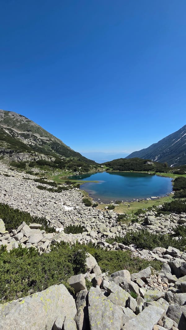 Rocky alpine lake in the Bulgarian mountains, clear summer day